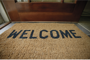 photo of a welcome mat in front of a door